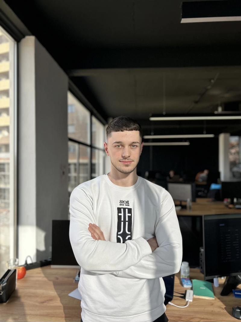 Besar Shabani standing in the studio with his arms crossed